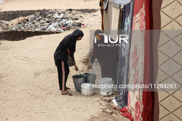 Displaced Palestinians are being seen among the tents in Deir el-Balah in the central Gaza Strip on May 28, 2024, amid the ongoing conflict...