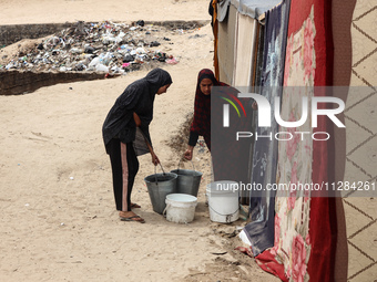 Displaced Palestinians are being seen among the tents in Deir el-Balah in the central Gaza Strip on May 28, 2024, amid the ongoing conflict...