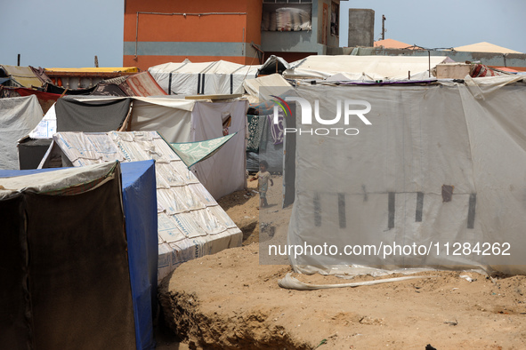 Displaced Palestinians are being seen among the tents in Deir el-Balah in the central Gaza Strip on May 28, 2024, amid the ongoing conflict...