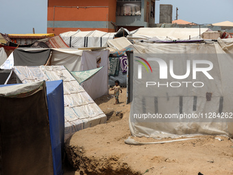 Displaced Palestinians are being seen among the tents in Deir el-Balah in the central Gaza Strip on May 28, 2024, amid the ongoing conflict...