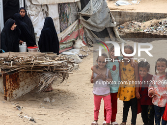 Displaced Palestinians are being seen among the tents in Deir el-Balah in the central Gaza Strip on May 28, 2024, amid the ongoing conflict...