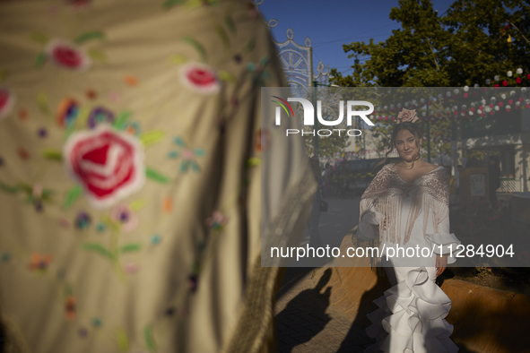 A woman is posing for a photo in a typical flamenco dress during the festivities of the Corpus Christi in Granada, Spain, on May 28, 2024. T...