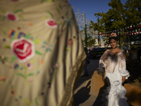 A woman is posing for a photo in a typical flamenco dress during the festivities of the Corpus Christi in Granada, Spain, on May 28, 2024. T...