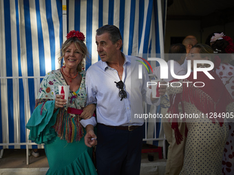 A group of people is drinking in one of the streets next to the ''casetas'' during the festivities of the Corpus Christi in Granada, Spain,...