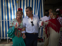 A group of people is drinking in one of the streets next to the ''casetas'' during the festivities of the Corpus Christi in Granada, Spain,...