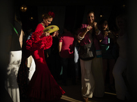 A woman is dressing in a typical flamenco dress and dancing during the festivities of the Corpus Christi in Granada, Spain, on May 28, 2024....