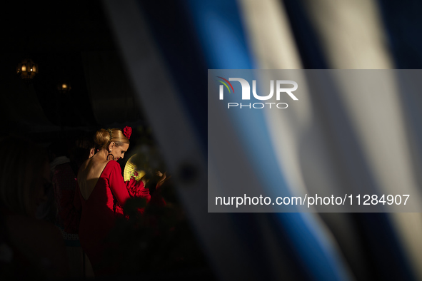 A woman is dressing in a typical flamenco dress and dancing during the festivities of the Corpus Christi in Granada, Spain, on May 28, 2024....