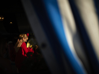 A woman is dressing in a typical flamenco dress and dancing during the festivities of the Corpus Christi in Granada, Spain, on May 28, 2024....