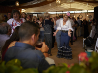 A woman is dressing in a typical flamenco dress and dancing during the festivities of the Corpus Christi in Granada, Spain, on May 28, 2024....