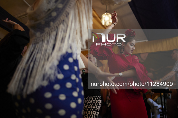 A woman is dressing in a typical flamenco dress and dancing sevillanas during the festivities of the Corpus Christi in Granada, Spain, on Ma...