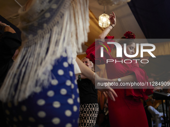 A woman is dressing in a typical flamenco dress and dancing sevillanas during the festivities of the Corpus Christi in Granada, Spain, on Ma...