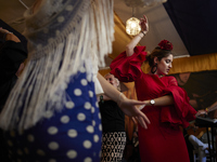 A woman is dressing in a typical flamenco dress and dancing sevillanas during the festivities of the Corpus Christi in Granada, Spain, on Ma...