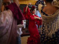 A woman is dressing in a typical flamenco dress and dancing sevillanas during the festivities of the Corpus Christi in Granada, Spain, on Ma...