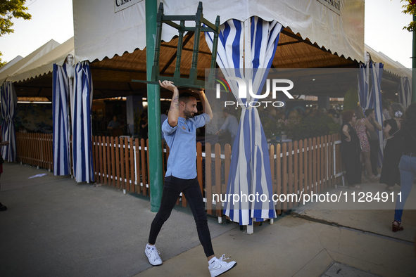 A waiter is carrying a table outside the ''caseta'' during the festivities of the Corpus Christi in Granada, Spain, on May 28, 2024. The Cor...