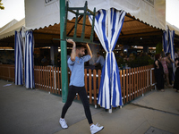 A waiter is carrying a table outside the ''caseta'' during the festivities of the Corpus Christi in Granada, Spain, on May 28, 2024. The Cor...