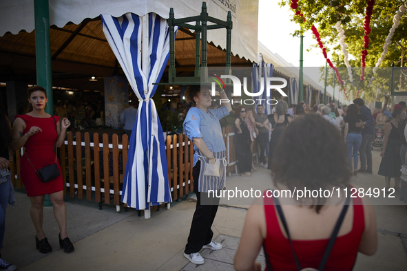 A waiter is carrying a table outside the ''caseta'' during the festivities of the Corpus Christi in Granada, Spain, on May 28, 2024. The Cor...