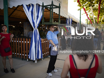 A waiter is carrying a table outside the ''caseta'' during the festivities of the Corpus Christi in Granada, Spain, on May 28, 2024. The Cor...