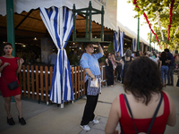 A waiter is carrying a table outside the ''caseta'' during the festivities of the Corpus Christi in Granada, Spain, on May 28, 2024. The Cor...