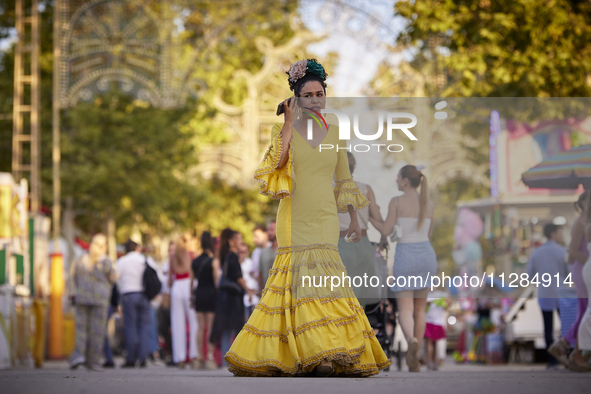 A woman is dressing in a typical flamenco dress and talking on her cell phone during the festivities of the Corpus Christi in Granada, Spain...