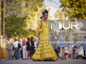 A woman is dressing in a typical flamenco dress and talking on her cell phone during the festivities of the Corpus Christi in Granada, Spain...