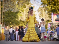 A woman is dressing in a typical flamenco dress and talking on her cell phone during the festivities of the Corpus Christi in Granada, Spain...