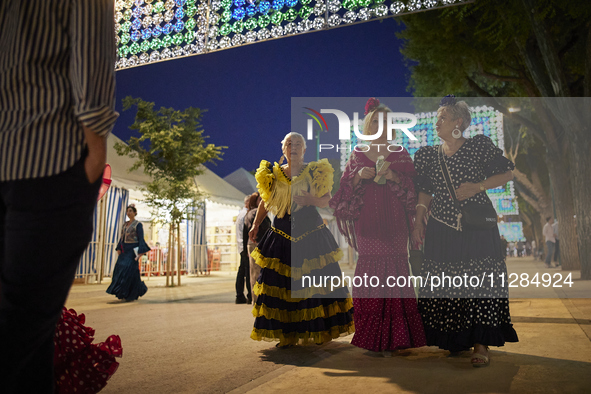 Women are dressing in typical flamenco dresses and walking during the festivities of the Corpus Christi in Granada, Spain, on May 28, 2024....