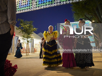 Women are dressing in typical flamenco dresses and walking during the festivities of the Corpus Christi in Granada, Spain, on May 28, 2024....