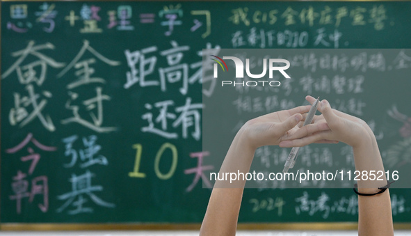 A senior three student is stretching during a self-study session at Fengfeng No 1 Middle School in Handan, China, on May 28, 2024. 