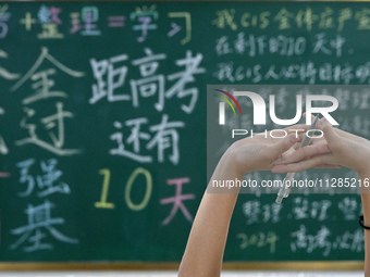 A senior three student is stretching during a self-study session at Fengfeng No 1 Middle School in Handan, China, on May 28, 2024. (