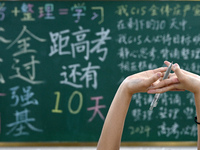 A senior three student is stretching during a self-study session at Fengfeng No 1 Middle School in Handan, China, on May 28, 2024. (