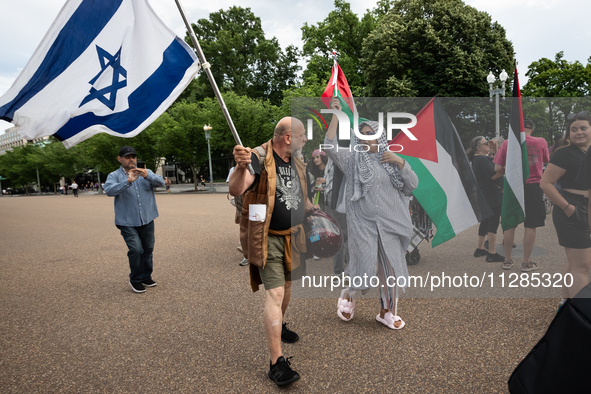 A Christian counter-protester with an Israeli flag tries unsuccessfully to provoke a fight with hundreds of people protesting in front of th...