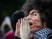 A man with face paint chants with hundreds of people protesting in front of the White House against the Israeli attacks on civilians in Rafa...