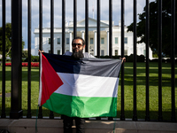 A man displays a Palestinian flag in front of the White House during a protest against the Israeli attacks on civilians in Rafah that have k...