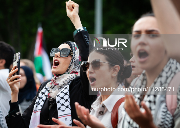 People chant slogans in front of the White House during a protest against the Israeli attacks on civilians in Rafah that have killed dozens...