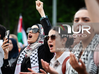 People chant slogans in front of the White House during a protest against the Israeli attacks on civilians in Rafah that have killed dozens...