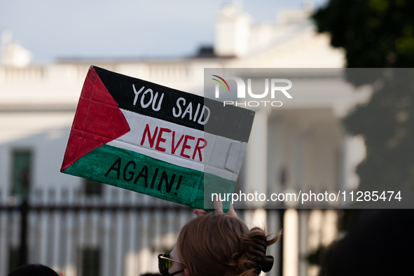 A demonstrator displays a sign that says ''Never Again'' in front of the White House during a protest against Israeli attacks on civilians i...