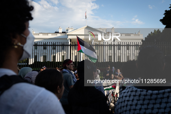 A Palestinian flag is displayed in front of the White House during a protest against the Israeli attacks on civilians in Rafah that have kil...