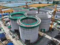 Workers are working at the construction site of a grain storage project of the Yandu branch of the Central Grain Reserve Yancheng Direct War...