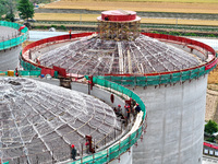 Workers are working at the construction site of a grain storage project of the Yandu branch of the Central Grain Reserve Yancheng Direct War...