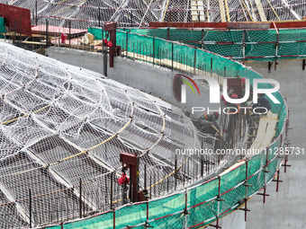 Workers are working at the construction site of a grain storage project of the Yandu branch of the Central Grain Reserve Yancheng Direct War...