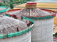 Workers are working at the construction site of a grain storage project of the Yandu branch of the Central Grain Reserve Yancheng Direct War...