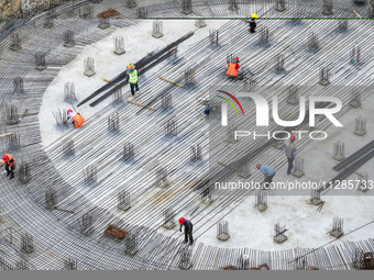 Workers are working at the construction site of a grain storage project of the Yandu branch of the Central Grain Reserve Yancheng Direct War...