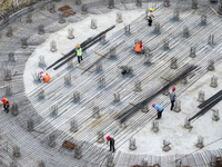 Workers are working at the construction site of a grain storage project of the Yandu branch of the Central Grain Reserve Yancheng Direct War...