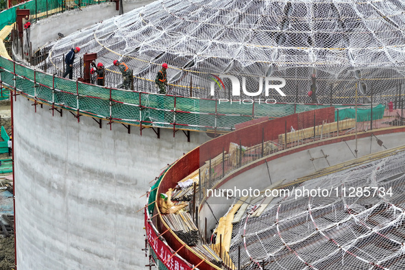 Workers are working at the construction site of a grain storage project of the Yandu branch of the Central Grain Reserve Yancheng Direct War...