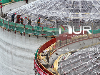 Workers are working at the construction site of a grain storage project of the Yandu branch of the Central Grain Reserve Yancheng Direct War...