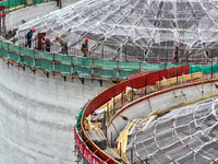 Workers are working at the construction site of a grain storage project of the Yandu branch of the Central Grain Reserve Yancheng Direct War...