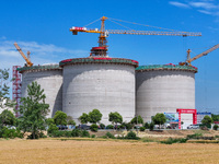 Workers are working at the construction site of a grain storage project of the Yandu branch of the Central Grain Reserve Yancheng Direct War...