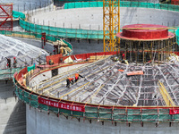 Workers are working at the construction site of a grain storage project of the Yandu branch of the Central Grain Reserve Yancheng Direct War...