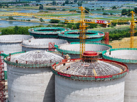 Workers are working at the construction site of a grain storage project of the Yandu branch of the Central Grain Reserve Yancheng Direct War...