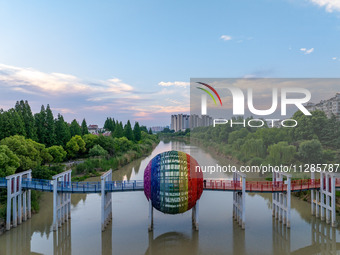 A photo is showing the North-South Geographical Boundary indication Garden in the Chaoxia district of Huai'an City, Jiangsu province, China,...